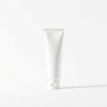 White hand cream tube standing upright